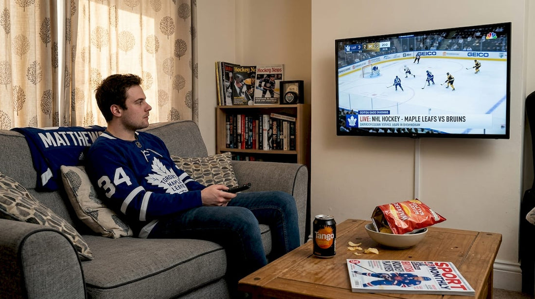 Young man watches NHL game in UK living room