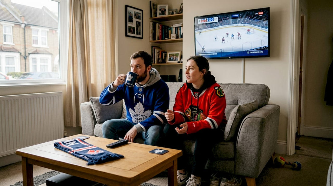 Two NHL fans wearing jerseys in living room