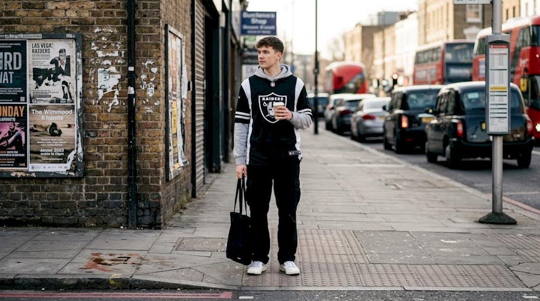 Man in NFL streetwear on busy city street