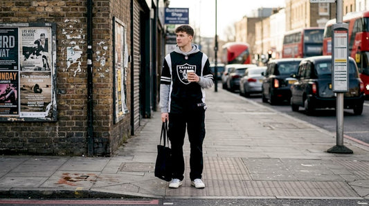 Man in NFL streetwear on busy city street