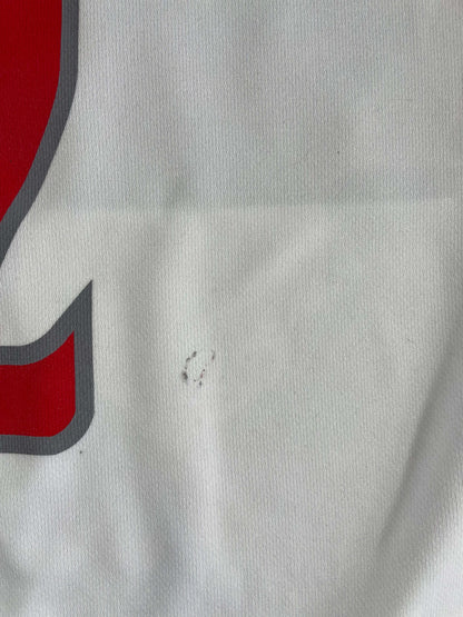 Close-up of a John Wall Washington Wizards NBA Jersey showing minor wear and a small mark on the classic white fabric.
